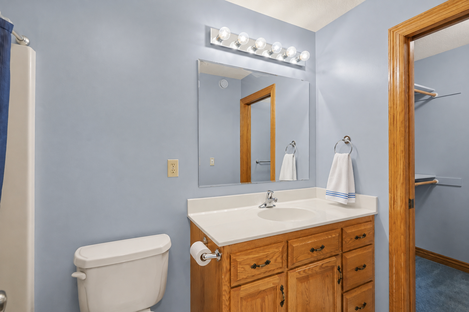 A private upper-level bath serves the junior suite, offering convenient ensuite access and a bathtub for added comfort. The thoughtful layout gives family members or guests their own welcoming, private space.
