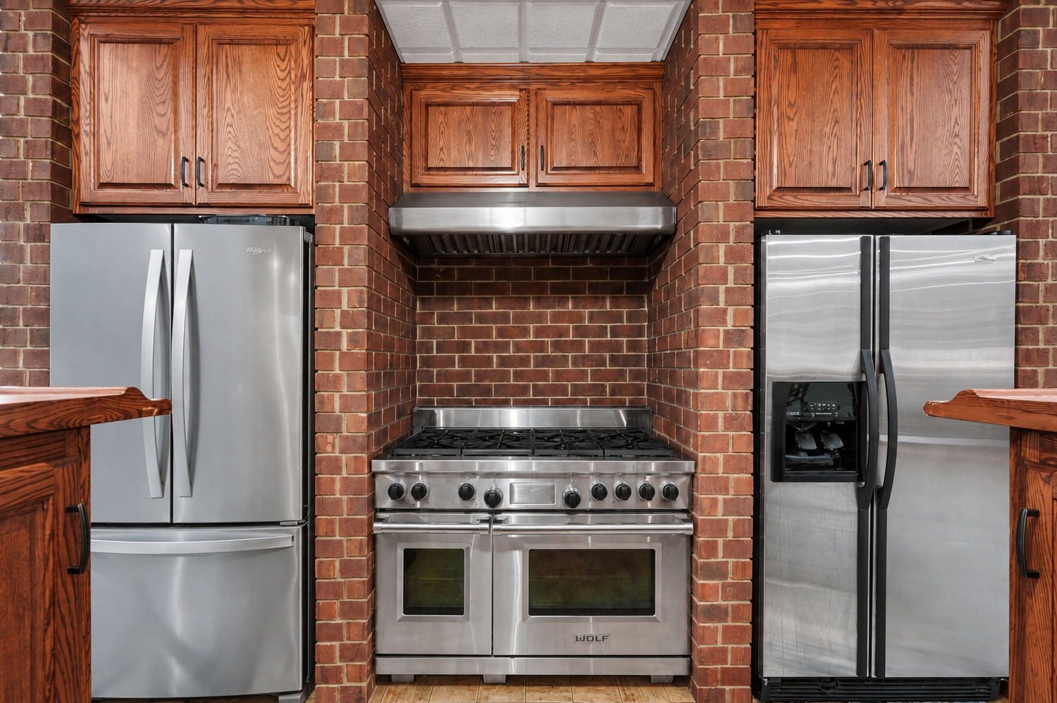This entertainer’s lower-level bar is exceptionally equipped with a Wolf 5-burner range, dual refrigerators and abundant cabinetry for effortless hosting. The brick surround and stainless finishes give the space a distinctive, upscale pub-style feel.