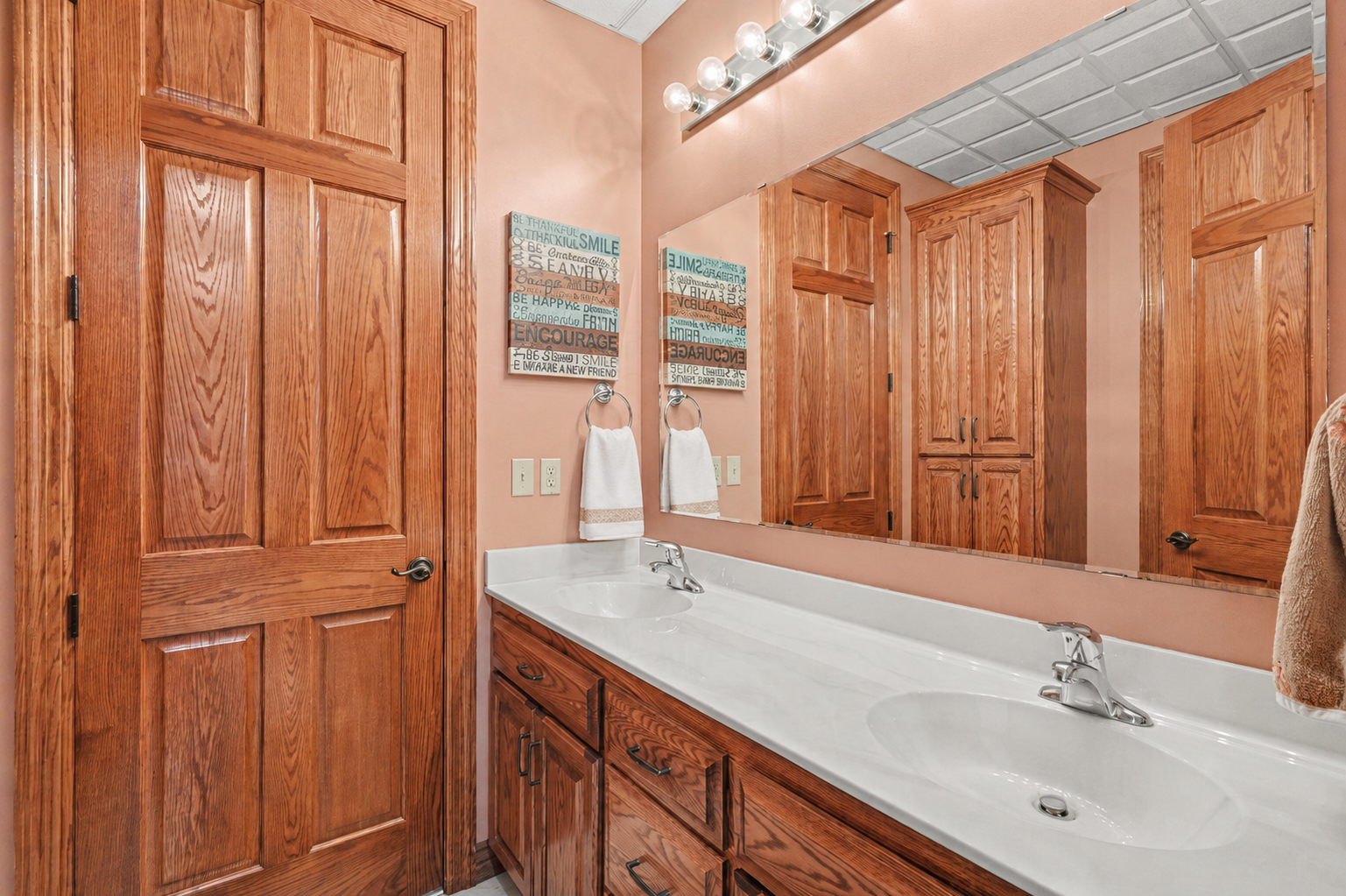 A lower-level Jack-and-Jill bath provides convenient access between bedrooms, with dual sinks, full bath and generous cabinetry to make busy mornings easier. The thoughtful layout offers privacy and function for family members or overnight guests.