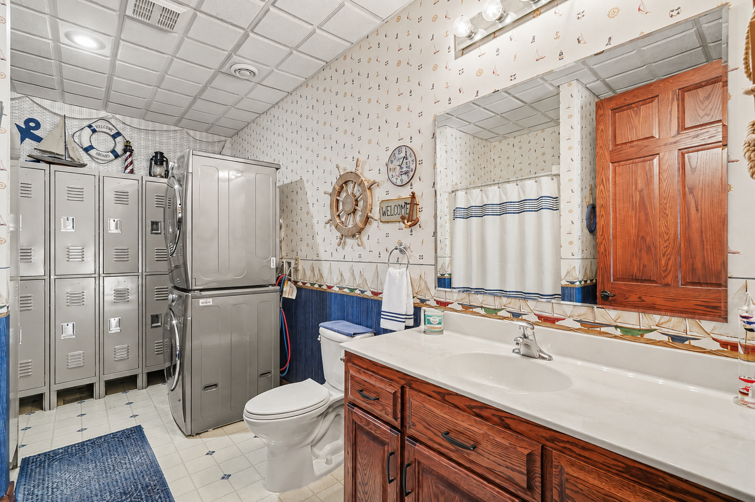 A convenient lower-level pool bath features a tub/shower combination, built-in lockers and a full-size washer and dryer. Perfect for pool days, it keeps towels, suits and gear organized while adding exceptional everyday function.