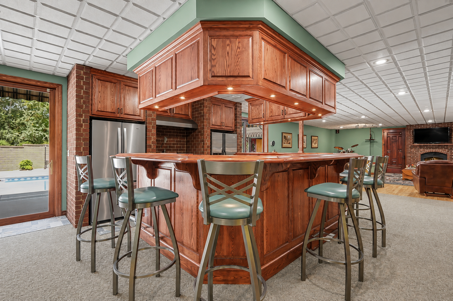 A full lower-level wet bar creates a fantastic gathering space with generous seating, rich cabinetry and room to serve family and friends with ease. Perfect for game days, parties or casual entertaining, it adds another fun and functional dimension t