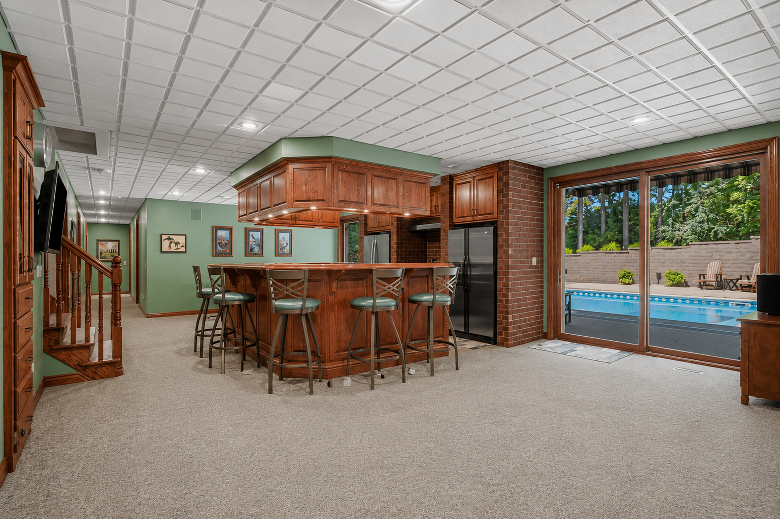 An entertainer’s dream, this expansive lower level features a full bar with generous seating, abundant cabinetry and plenty of room to gather. Direct access to the pool area makes it easy to take the fun from indoors to out.