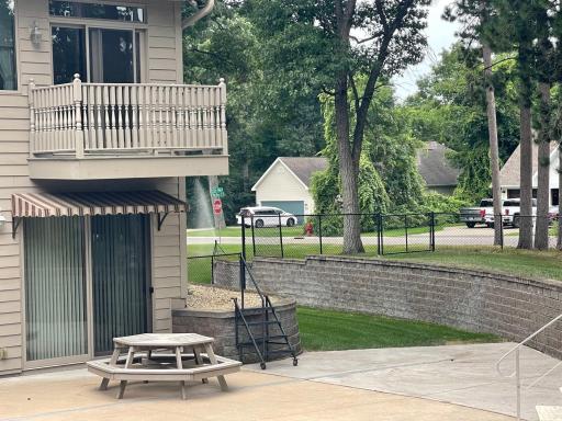 One of two convenient walkouts from the lower level leads directly to the pool and patio, creating easy flow for entertaining and everyday use. Nearby gated yard access adds another practical connection to the outdoor spaces.