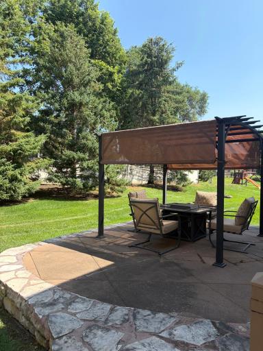 Stone patio with a tree line for privacy