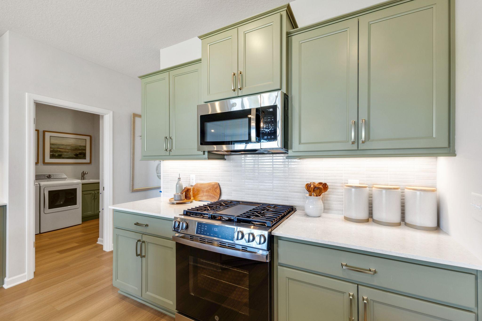 GE appliances including a gas range, microwave, dishwasher, and refrigerator are all included! Photo of model home, colors and finishes may vary.