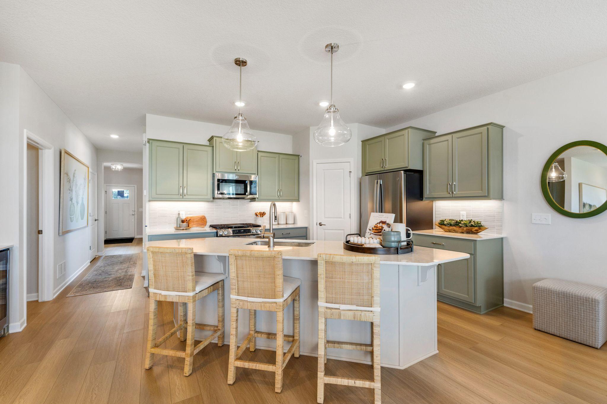 Kitchen is spacious and features a large island with sink. Photo of model home, options and finishes may vary.