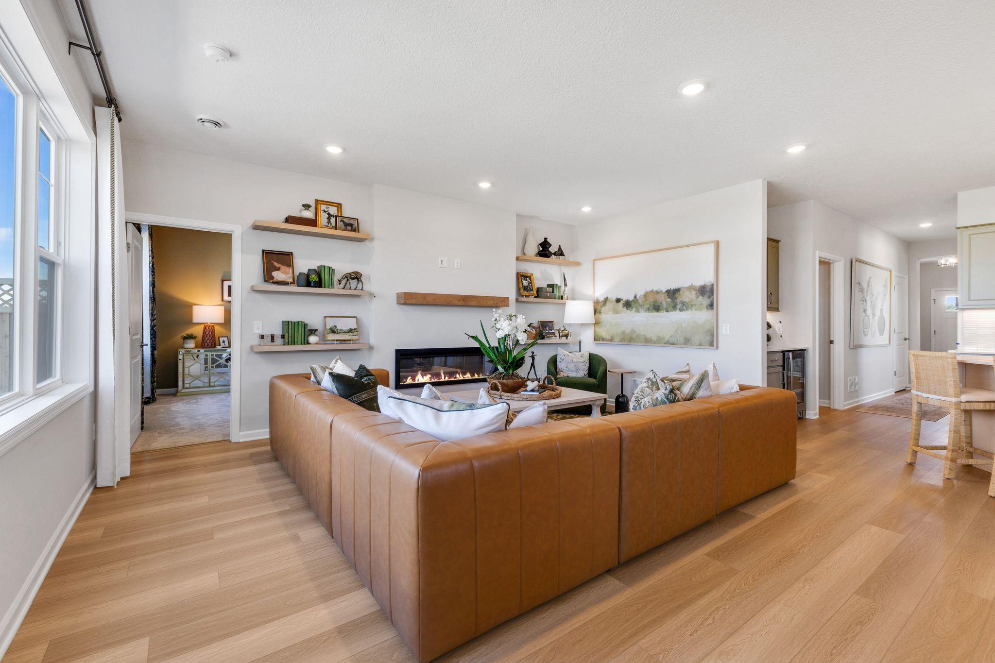 With LVP throughout the open concept family room and dining room, the space is flexible for a variety of different furniture layouts. Photo of model home, colors and finishes may vary.