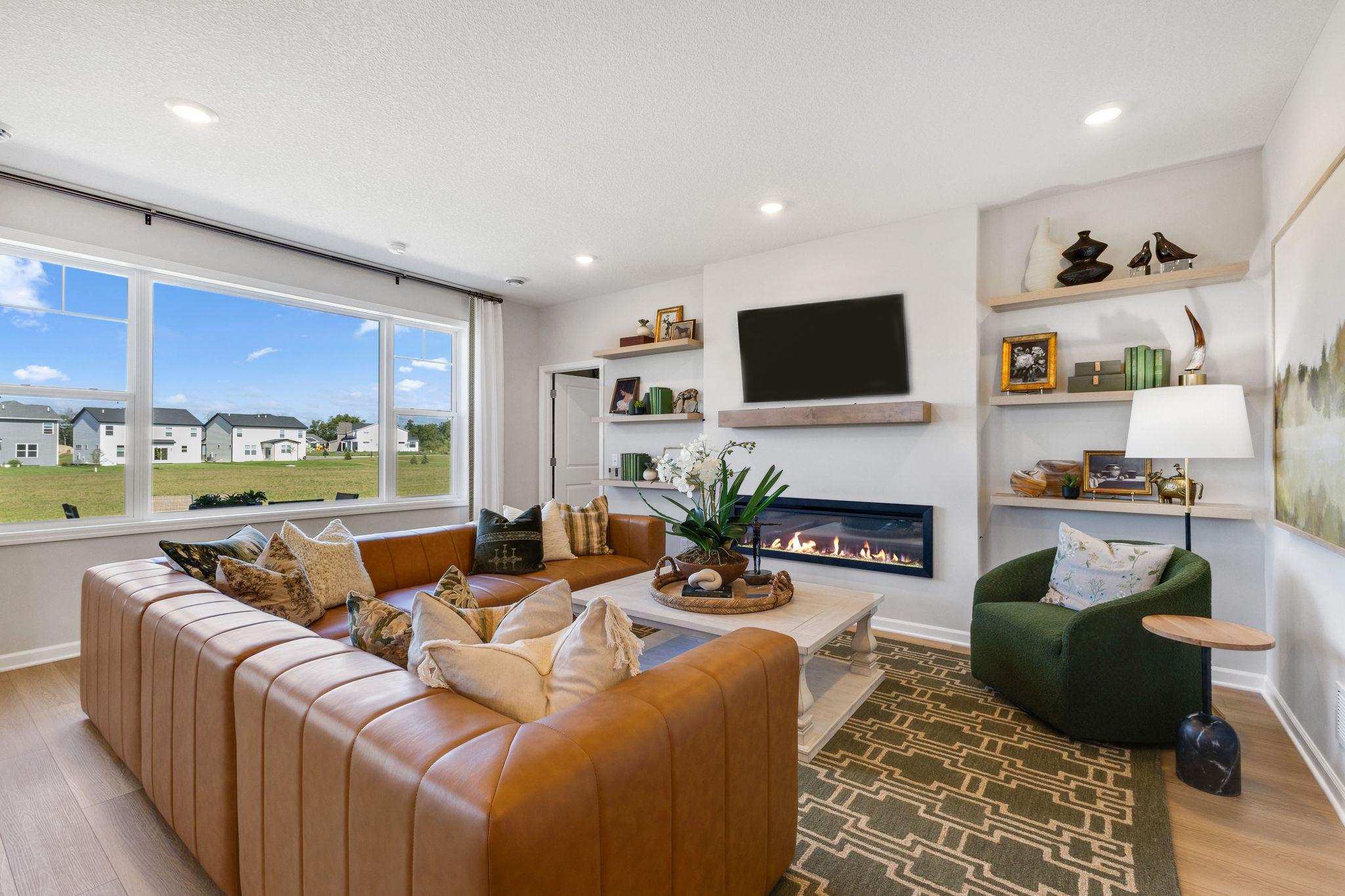 The family room is anchored around a low maintenance electric fireplace that keeps the room feeling very open. Bonus is that you can use the fireplace with or without heat! Outlet is already in place to hang your TV over the fireplace.