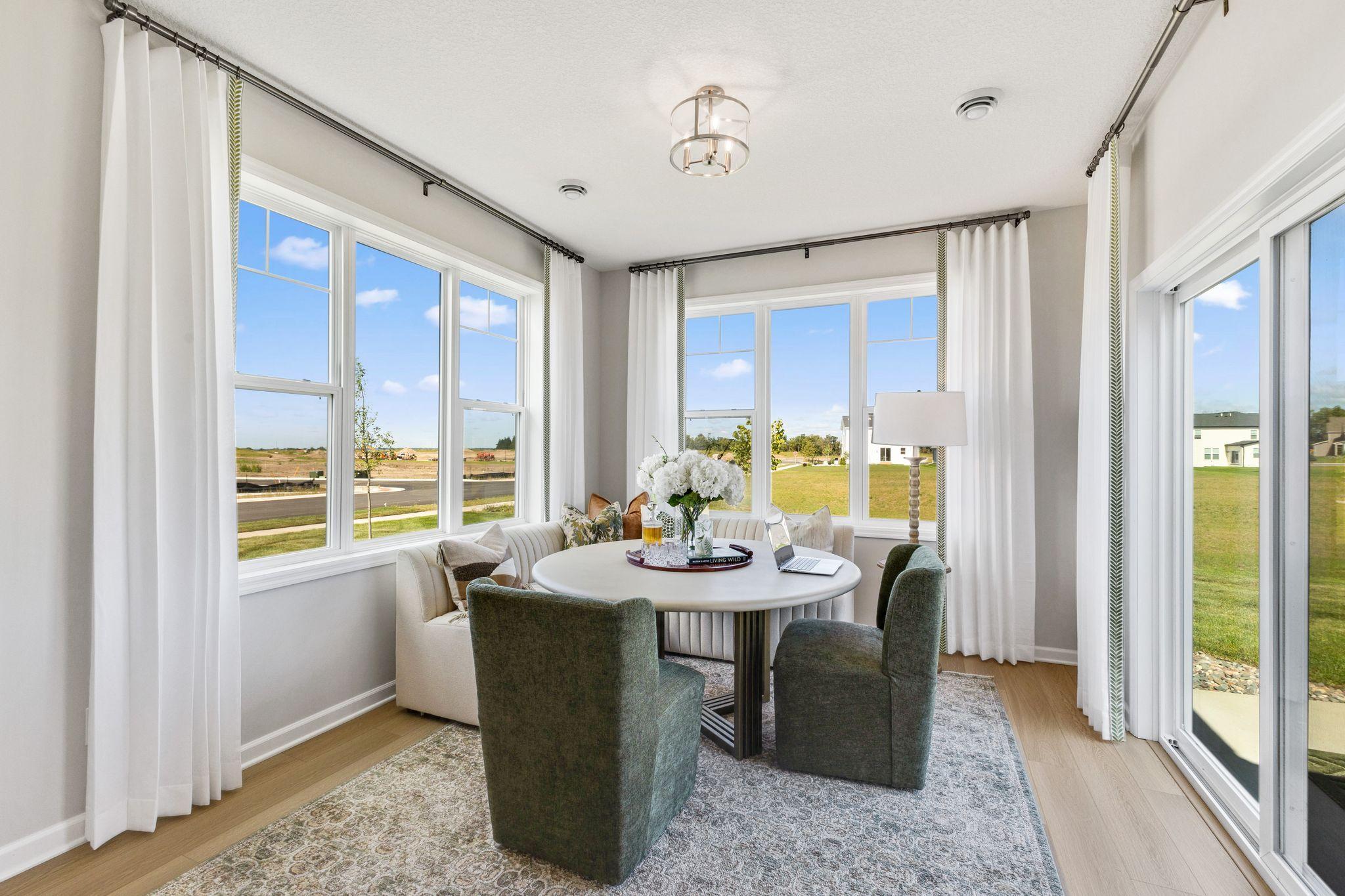 The morning room is the perfect place to sip your morning coffee and enjoy your backyard views! Photo of model home, views from actual home differ.