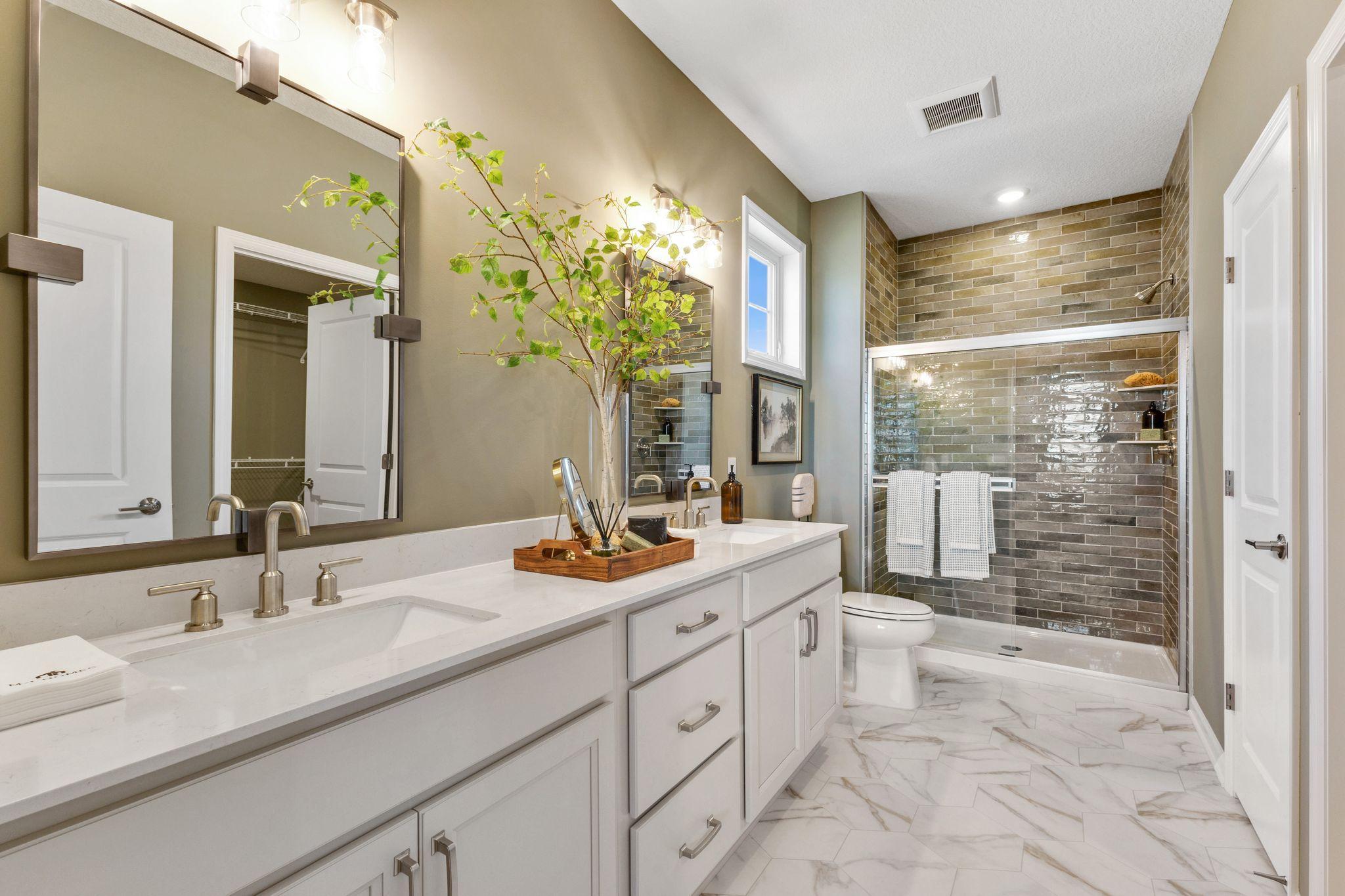 Owner's bath features dual sinks, a gorgeous tiled shower with glass doors, a HUGE walk-in closet and linen closet. Plus a window positioned higher up on the wall for natural light!