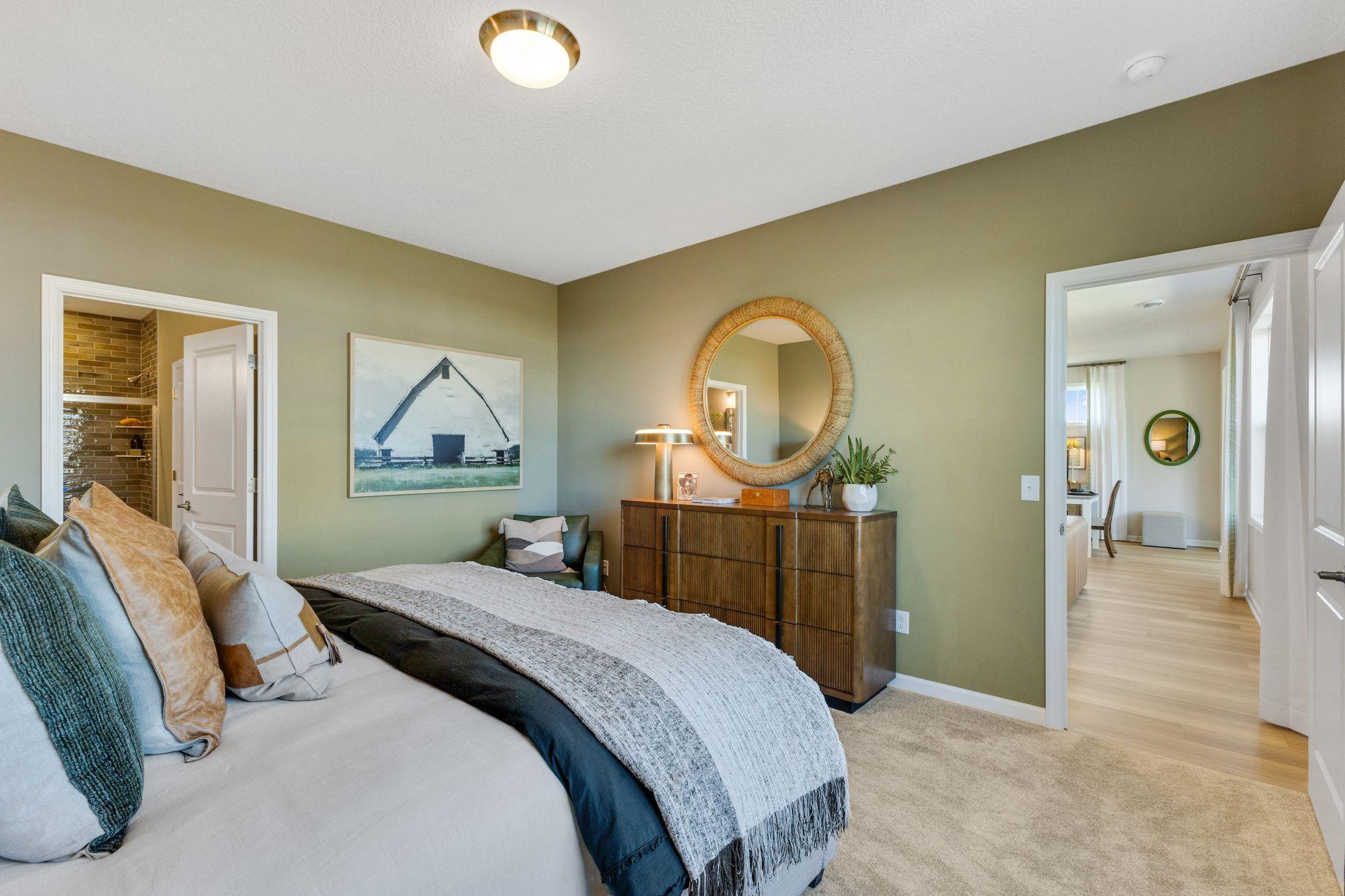 Owner's suite looking out to the family room area. Photo of model home, colors and finishes may vary.