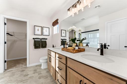 Owner's en-suite bathroom with dual sinks, shower and walk-in closet. - Photo is representational of approx. floorplan. Staged model. Finishes will be different than actual home.