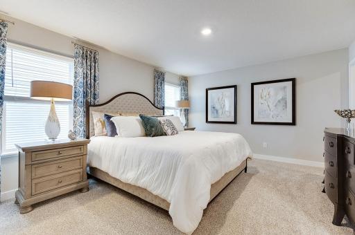 Primary bedroom features bountiful space for a king size bed, two bedside tables and accent furniture. **Pictures are of model home; actual finishes will vary.
