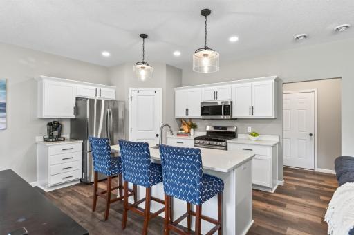 Tucked right in the corner of this bright, modern kitchen is a dedicated walk-in pantry, giving you all the storage space you need to keep your counters clutter-free.