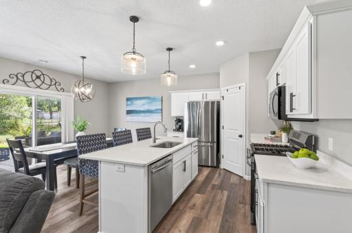 A spacious center island with quartz counter tops though-out the kitchen & cabinet space make this kitchen ideal for cooking, hosting, and everyday living.