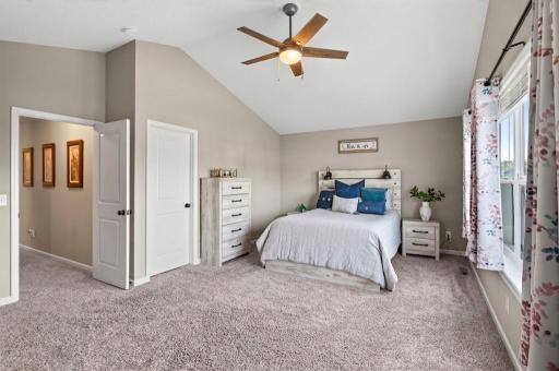 Your peaceful sanctuary awaits! Vaulted ceilings and generous square footage make this primary bedroom feel airy, calm, and incredibly spacious—the ultimate retreat at the end of the day.