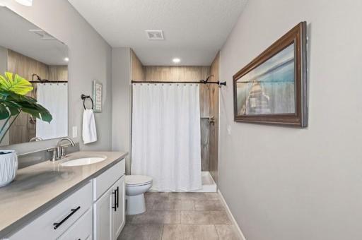 Spa-like relaxation at home! Connected right off the primary suite, this ensuite bathroom offers sleek modern finishes and a calm, coastal-inspired vibe for your daily routine.