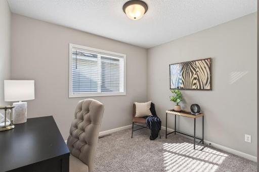 This secondary bedroom easily adapts to whatever your lifestyle needs—whether that's a dedicated workspace, guest room, or creative studio.