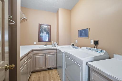 Main level laundry room features ample storage space