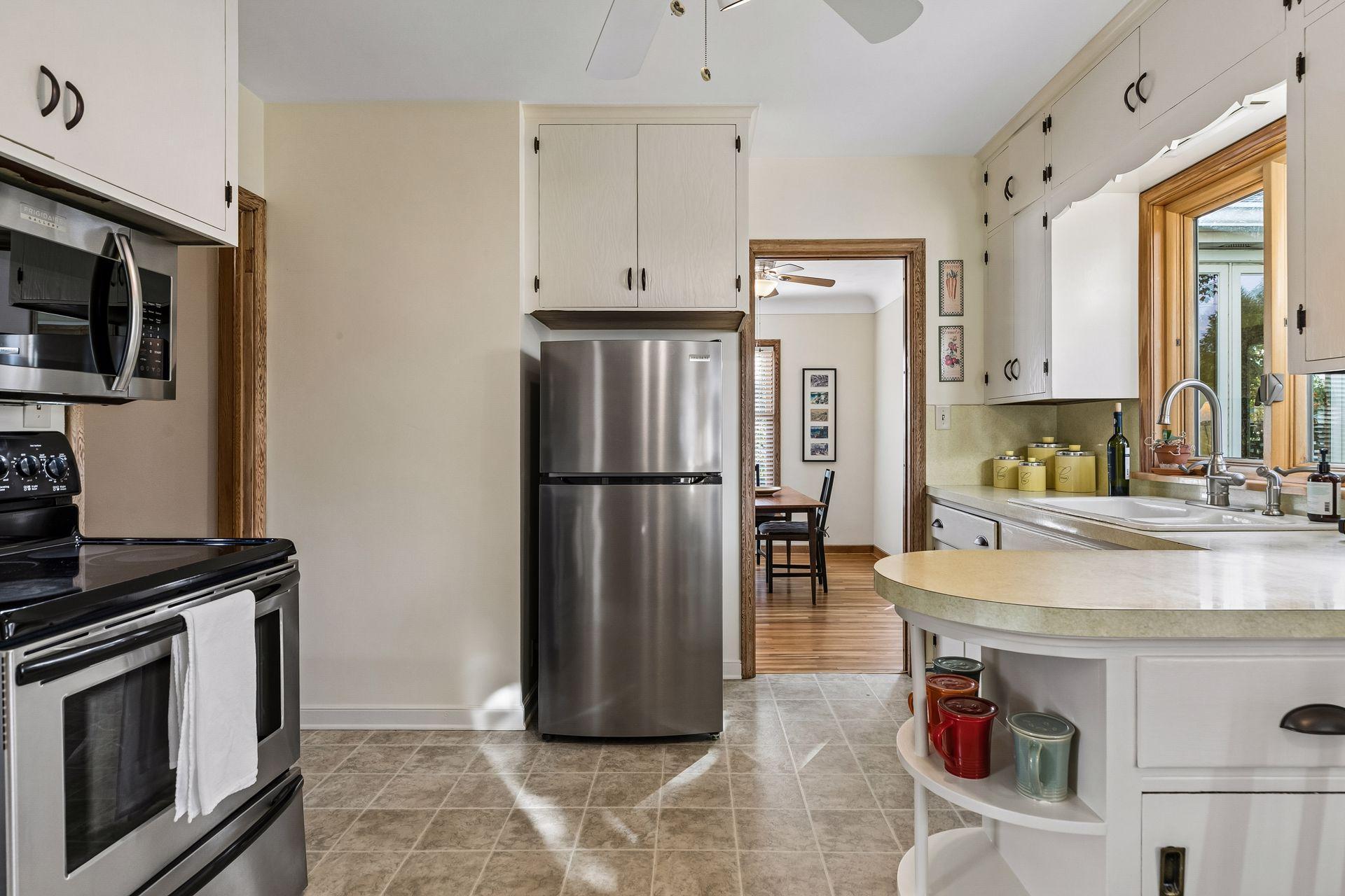 Kitchen opens to dining room and four season porch