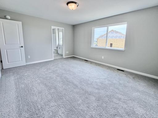 PHOTO OF A DIFFERENT HOME WITH SIMILAR PLAN AND FINISHES. Primary Suite.