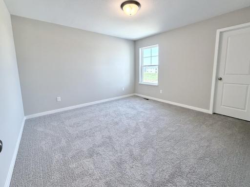 PHOTO OF A DIFFERENT HOME WITH SIMILAR PLAN AND FINISHES. Bedroom 2.