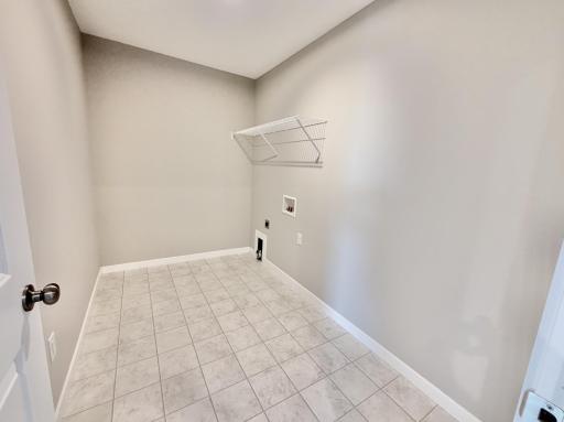 PHOTO OF A DIFFERENT HOME WITH SIMILAR PLAN AND FINISHES. Upper level laundry room.