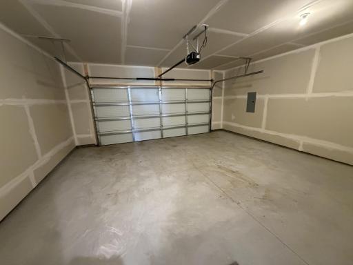PHOTO OF A DIFFERENT HOME WITH SIMILAR PLAN AND FINISHES. Garage.