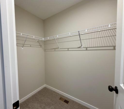 PHOTO OF A DIFFERENT HOME WITH SIMILAR PLAN AND FINISHES. Bedroom 2 Walk-in Closet.