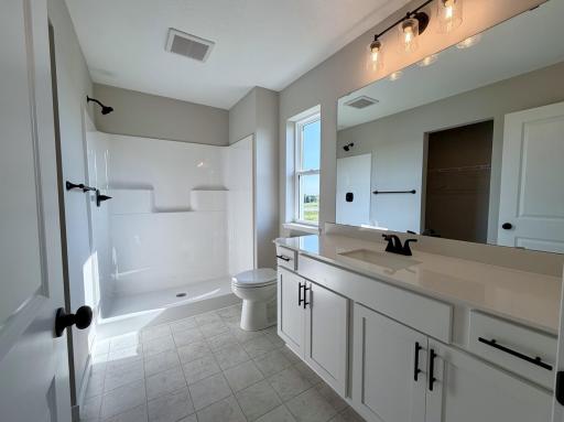 PHOTO OF A DIFFERENT HOME WITH SIMILAR PLAN AND FINISHES. Primary Suite Bathroom
