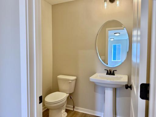 PHOTO OF A DIFFERENT HOME WITH SIMILAR PLAN AND FINISHES. Main floor half bath.