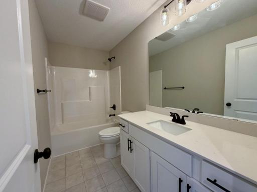 PHOTO OF A DIFFERENT HOME WITH SIMILAR PLAN AND FINISHES. Upper floor main full bathroom.