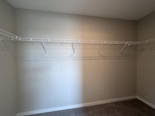 PHOTO OF A DIFFERENT HOME WITH SIMILAR PLAN AND FINISHES. Primary Suite Walk-in Closet.