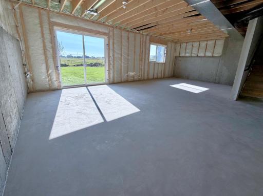 PHOTO OF A DIFFERENT HOME WITH SIMILAR PLAN AND FINISHES. Unfinished Walkout Lower Level ready for future finish including future family room, bedroom 4, and 4th bathroom.