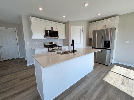 PHOTO OF A DIFFERENT HOME WITH SIMILAR PLAN AND FINISHES.