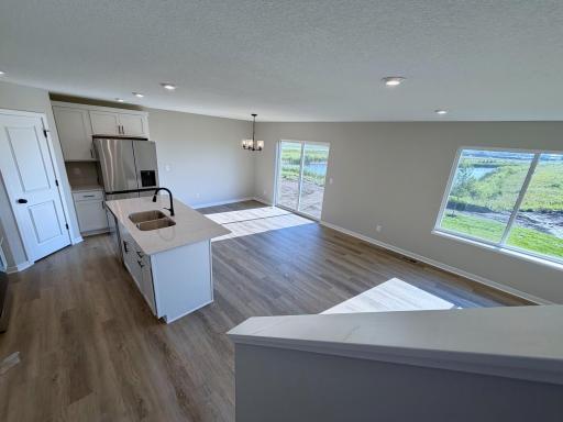 PHOTO OF A DIFFERENT HOME WITH SIMILAR PLAN AND FINISHES.