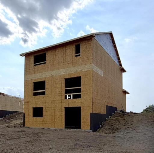 3050 Jandura Ave NE- Rear elevation features a Walkout Lower Level! Sod, Irrigation System, and Front Plantings included. Sliding patio doors and windows will be installed soon.