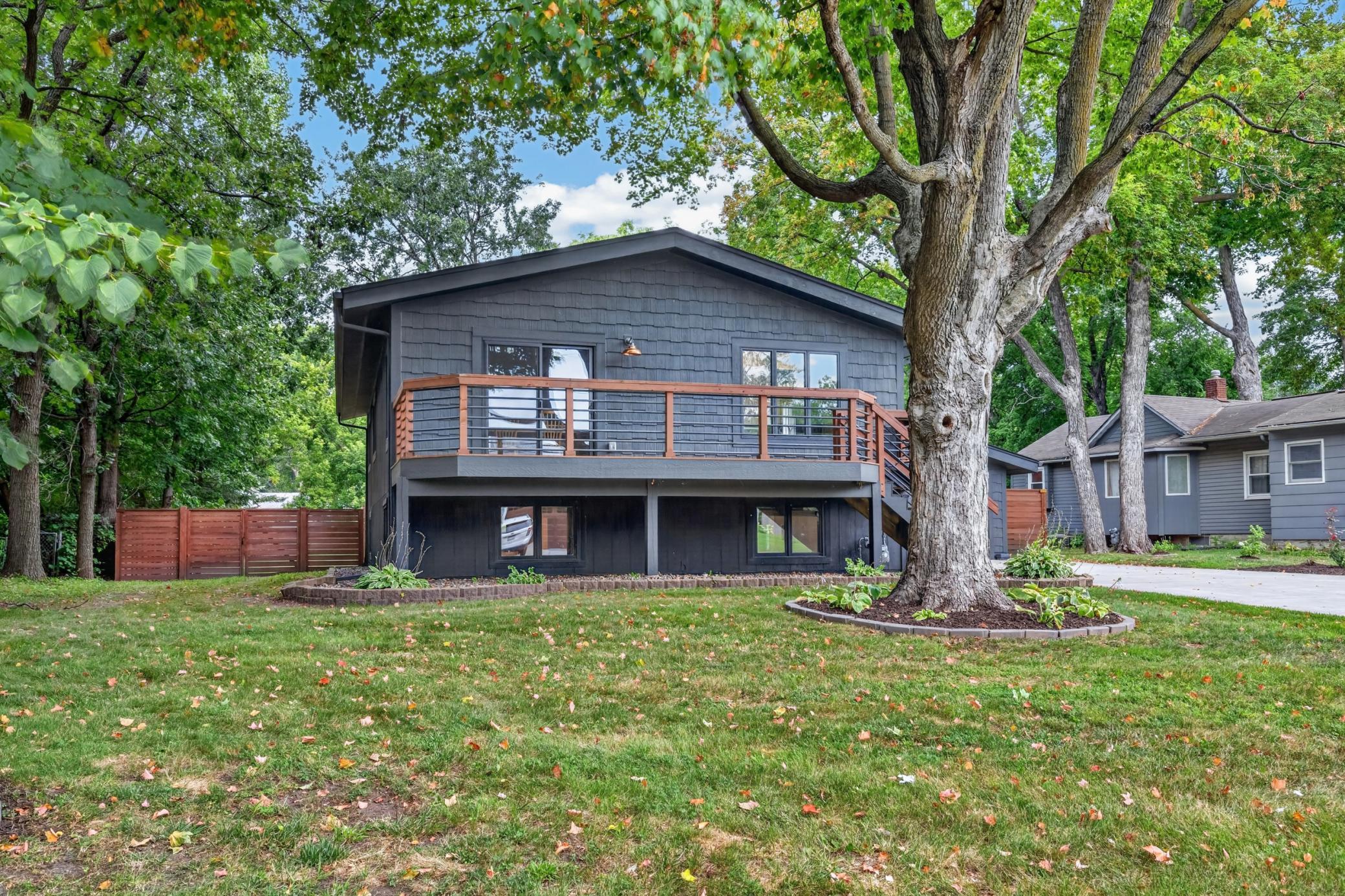 Home is wrapped in painted cedar ceiling and cement board accent shakes.