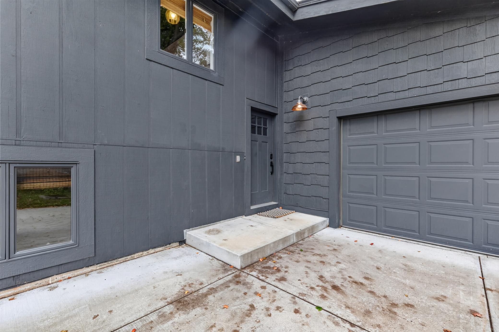 Front door - craftsman style entry door. 2-car garage offers an additional entry door with access to the backyard