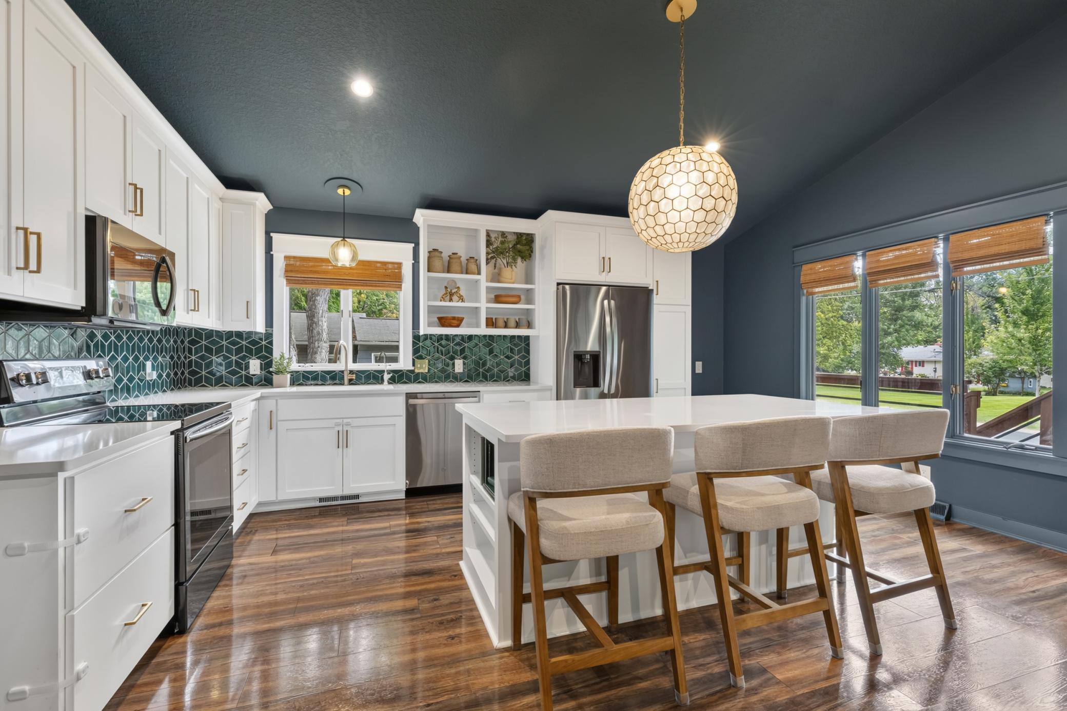 The Kitchen features enameled cabinetry that offers flat panel doors, roll-out storage, open display shelving and "Eat-In" center island