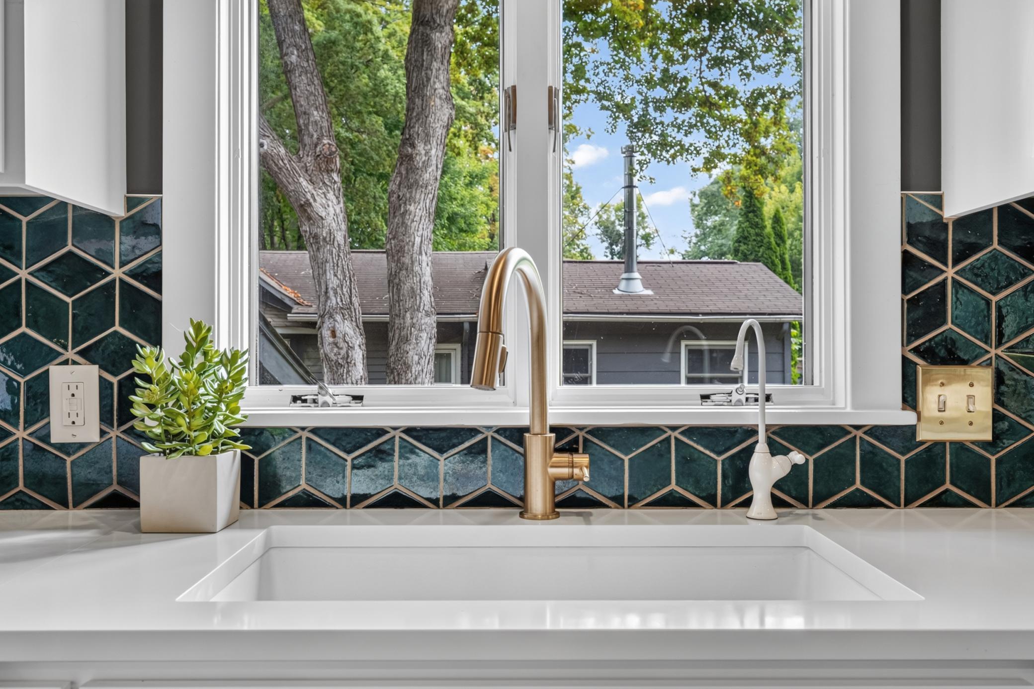 Quartz countertops, composite sink and decorative tile backsplash
