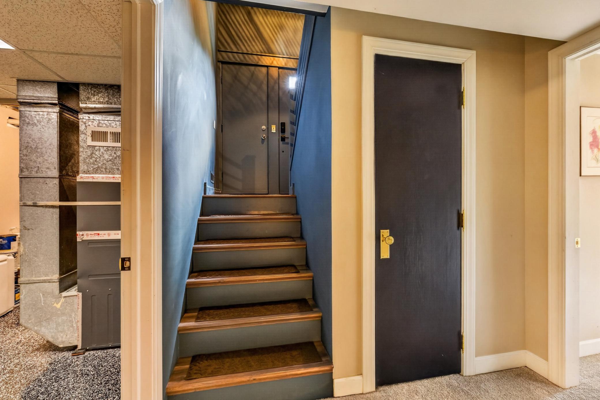Lower Level features 2 bedrooms and 1 bathroom. On the left is the laundry / utility room. On the right is bedrooms.