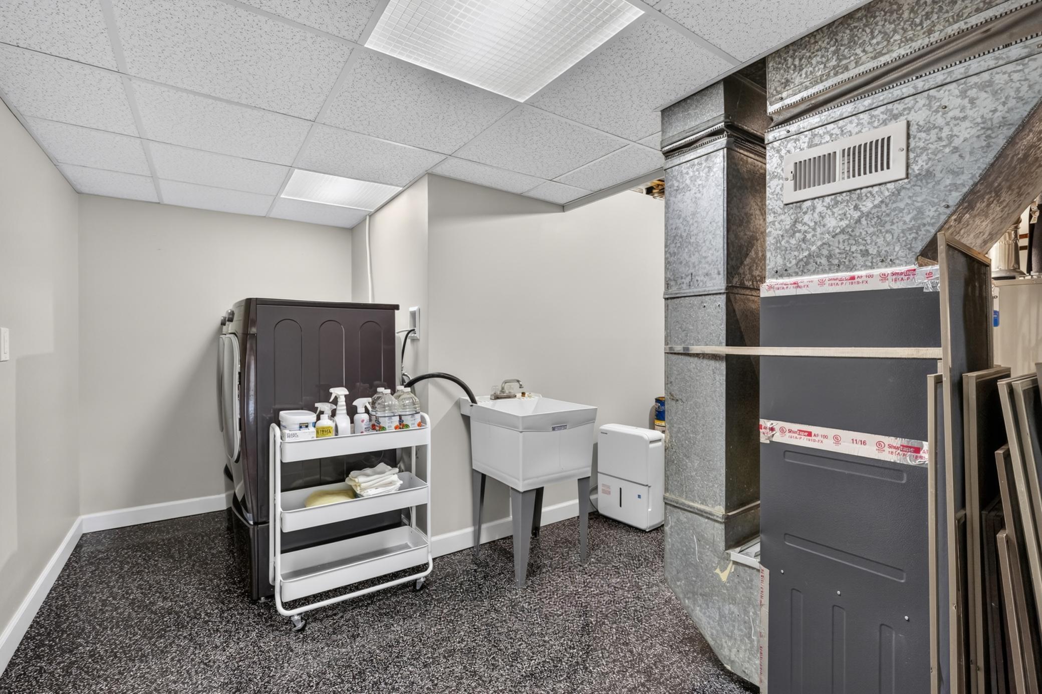 Laundry & Utility Room features epoxy coated flooring and a laundry tub