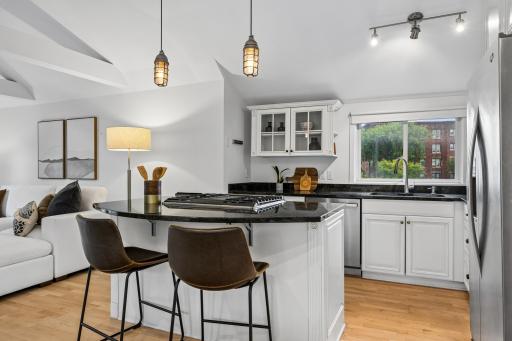 Updated kitchen with a center island serving a breakfast bar, offering a functional space for cooking, dining, and gathering