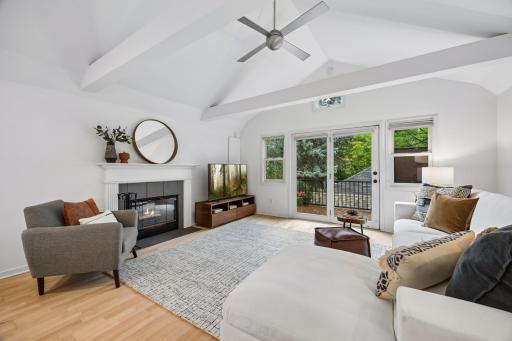Bright living room with vaulted ceilings and a gas fireplace creating a warm focal point for the space.