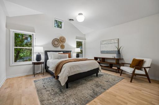 Spacious primary bedroom with vaulted ceilings, creating an open and airy retreat.