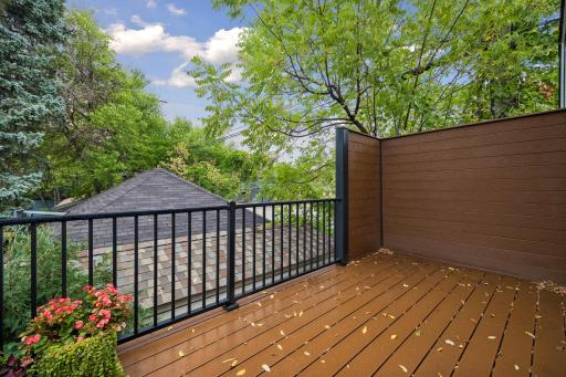 Maintenance-free deck with a privacy wall, offering a comfortable space for outdoor dining and relaxing.