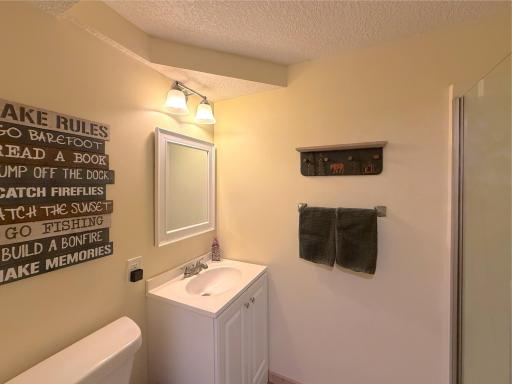 The lower-level three-quarter bathroom offers a walk-in shower and clean, functional finishes, providing added convenience for family and guests.