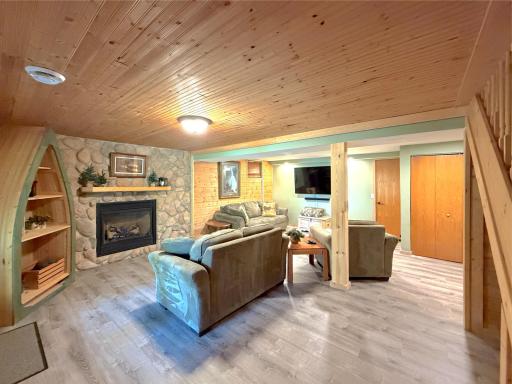 The finished lower level expands your living space with a spacious family room anchored by a stunning floor-to-ceiling stone gas fireplace and opens to the recreation area.
