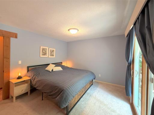 The spacious primary bedroom offers a peaceful retreat with soft natural light, neutral finishes, and plenty of room to relax and recharge, the perfect space to recharge.